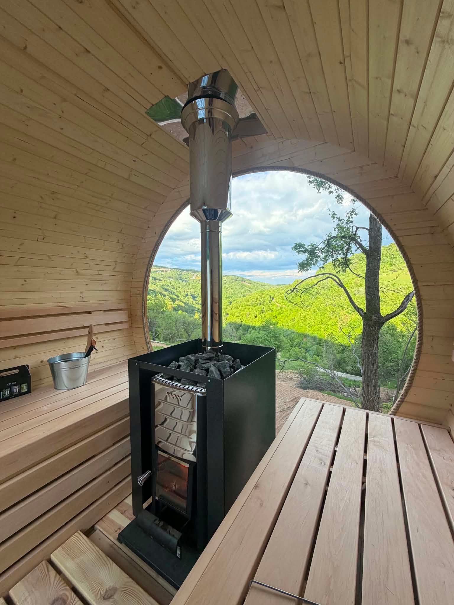 Kim's Jacuzzi sauna interior with wood-burning stove and panoramic mountain view
