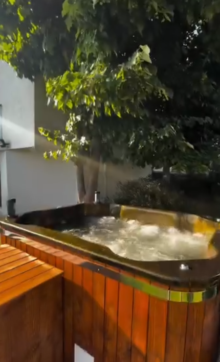 Hot tub on a wooden deck in a misty mountain landscape